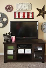 Custom media room home theater complete with gray sectional couch, gray carpet, black walls, projection tv, stainless steel wall sconces, and orange artwork to. Red Hen Home Theatre Room Knock Off Theater Room Decor Living Room Theaters Movie Room Decor