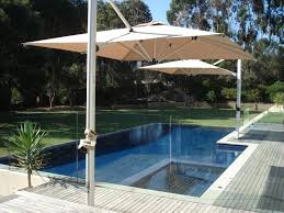 Two Square Cantilever Umbrellas Providing Great Shade Coverage Over A Pool Small Pool Ideas Pool Umbrellas Pool Shade Backyard Shade