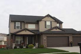 Minimalist brick exterior home photo in austin brick and siding. Dark Roof Mastic Musket Brown Trim Mastic Pebblestone Clay Siding Normal Il Carlson Exteriors Inc