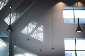Dimmable indirect lighting was installed on top of the panels to provide ambient light for the space, while creating a secondary ceiling line to help make the room feel more comfortable for people. Lighting Solutions For Sloped And Vaulted Ceilings Obriens Lighting Blog