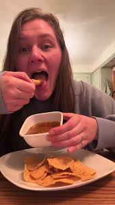 The easiest & cheapest nachos you’ve ever made! 1 jar nacho cheese 1 can  chili (with meat and beans) 1 bag of tortilla chips Combine cheese and  chili together in a pot. Heat through