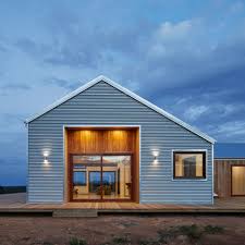 Concrete wall of a cereal silo tower with vents. Corrugated Steel Provides Durable Facade For House By Glow Design Group