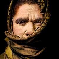 A young child wearing a hooded jacket and scarf. Women nun face, work.