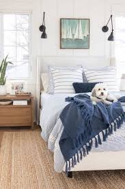 Steal a few of these stylish tricks. White Upholstered Bed Lake House Master Bedroom Blue And White Lakehouse Masterbedroom Coa In 2020 White Bedroom Decor White Upholstered Bed Coastal Cottage Bedroom