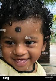 Indian Baby Boy With Black Curling Hair Or Infant Smiling With Laugh Stock Photo Alamy