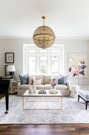 Neutral Toned Living Room Pink And Blue Accents Wicker Globe Pendant Light Gold Living Room Living Room Inspiration Apartment Living Room