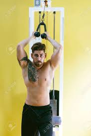 Retract your scapula, which should create an arch leaning away from the machine. Fit Man On Lat Pull Down Machine At The Health Club Work Out Stock Photo Picture And Royalty Free Image Image 153656146