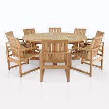 Traditional setting for a compact dining room furnished with a round table made out of oak wood top with a shiny, polished finish paired with a set of six the set of furniture includes six matching chairs with faux leather comfy upholsteries. Teak Dining Set Capri Round Wood Cafe Table 8 Chairs Teak Warehouse