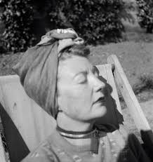 Photograph of Eileen Agar sitting in a deck chair in a garden. Possibly  taken at Simone and David Dear's country home in Sussex., Joseph Bard,  [1947]