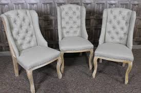 Winged Dining Chairs With An Exposed Framework French Style Buttoned Linen Dining Chairs Dining Chairs Comfortable Dining Chairs