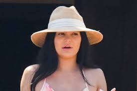 In fact, it's kind of her thing. Kylie Jenner Vacations In Neon Orange Bikini Cutout Tangerine Dress Footwear News