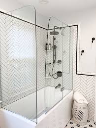 When tiling a shower, one of the most important things to remember is that you need extra cuts in the tiles to make sure they follow the fall of the floor, and that. Corner Porcelain Tub With Herringbone Backsplash And Black Trim Modern Bathroom Philadelphia By Dremodeling Houzz