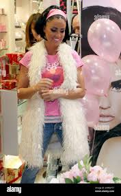Katie Price (aka Jordan) signs autographs and poses for photographers at a  photo call at Belfast's Forestside Shopping Centre to promote her new  perfume Precious Love. Katie wore a fuzzy white vest,
