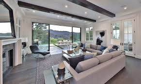 Then add touches of color with the textiles in the room with a throw blanket wall art decorative pillow or a large rug. Modern Luxury Living Room With View Luxury Living Room Design Living Room Interior Modern Modern Luxury Living Room