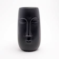 Characterised by its matte black finish and organic face shape. Trouva Black Ceramic Pagan Face Vase