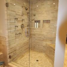 Go for mosaic glass tiles in a recurring border, or use a border of black tiles to divide a white and brown mosaic tile creation, breaking up the wall space. Walk In Shower Tile Designs Shower Tile Ideas Www Westsidetile Com