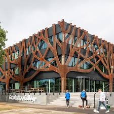 With its many different seats, the atrium functions as a meeting place and canteen for the 650 students. Cepezed Designs Graafschap College Doetinchem With Corten Tree Facade