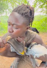 Boy in Woods Eating Chicken