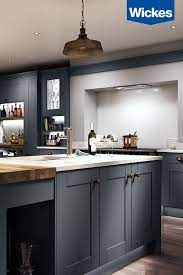 A minimalist miele vent hood also serves as a perch for a love bird trinket, adding whimsy in the hardworking space. A Dream Kitchen For Entertaining The Deep Charcoal Kitchen From Wickes Is The Ideal Backdrop For Entertaining In St Kitchen Design Home Kitchens Kitchen Decor