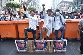 In this image provided by the democratic voice of burma (dvb), protesters in yangon hold images of. Jiah Mje5sgfhm