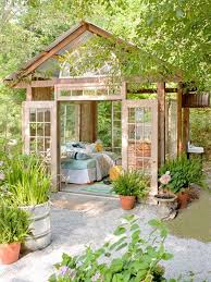 Well Lit She Shed Made Of Glass And Wood With Two Open Doors Garden With Lots Of Potted Plants And Trees Backyard Gazebo Backyard Patio Design
