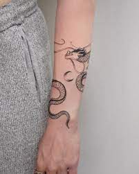 Tatti 040 Tattoos On Instagram A Delicate Dragon That Wraps Around The Arm Swipe To See It In Action Around Arm Tattoo Arm Tattoos Snake Wrap Around Tattoo