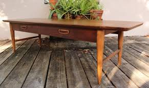This coffee table features a brazilian rosewood top with a crafted walnut base showcasing a fusion of geometric forms with impeccable craftsmanship. Sold Lane Surfboard Coffee Table Etsy Surfboard Coffee Table Mid Century Coffee Table Table