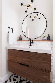 These impressive units can also provide you with the illusion of more space by freeing up room on the floor. Black And White Single Vanity Bathroom With Round Mirror Hgtv