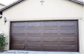 If Your Garage Door Is Looking A Little Beat Up You Can Give It A Makeover Wood Staining Your Aluminum Diy Garage Door Garage Door Makeover Garage Door Design