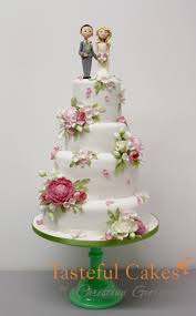 This classic floral wedding cake is filled with vanilla sponge, vanilla cream and mixed fruit jam for the sweet flavour. A Pastel Scattered Flower Wedding Cake Tasteful Cakes By Christina Georgiou