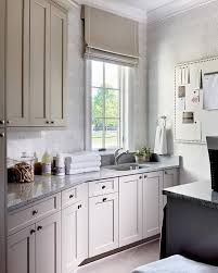 Light gray granite countertops with white cabinets. Roman White Granite Counters Design Ideas