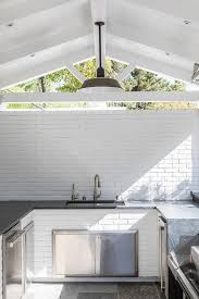white brick outdoor kitchen with sink