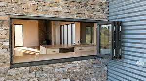 A frameless kitchen servery window that slides and stacks to create an open space for optimal accessibility. Aluminium Bi Fold Windows Bradnam S Windows Doors