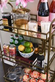 Bar carts should be visually appealing, so display just a few of your favorite glasses and bottles rather than putting there's nothing more glamorous than a gold bar cart. How To Style A Bar Cart Visions Of Vogue