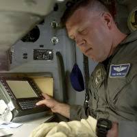SENIOR AIRMAN Michael C. Randag, 815th Airlift Squadron, Keesler AFB checks  to ensure the U.S. Army vehicles are secured inside the C-130 aircraft at  the Kansas City Downtown Airport. The C-130 Hercules