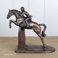 A bronze horse statue of a woman and her reining horse performing a sliding stop. Horses Side Saddle Cold Cast Bronze Horse Sculpture By Harriet Glen Collectables