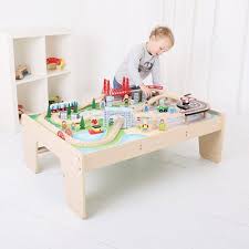 A crane lifts and lowers cargo onto the train and a helicopter soars over the town with blades spinning. Thomas Train Tables Target
