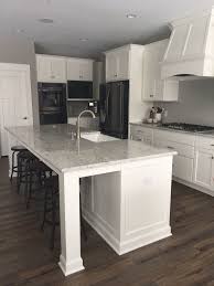 This White Kitchen Is Classic Yet Modern And Features Crisp White Cabinetry An Oversized Fu Black Appliances Kitchen White Kitchen Appliances White Cabinetry This stunning black and white kitchen is practically split in half: