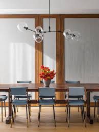 Midcentury Modern Dining Room With Blue Chairs Globe Light Chandelier Dining Room Light Fixtures Dining Room Lighting Mid Century Dining Room
