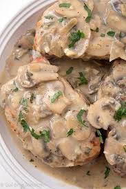 Pork Chops With Creamy Mushroom Sauce So Moist And Baked To Perfection With An Out Of This World Creamy Sauce Slow Cooker Pork Chops Pork Recipes Recipes