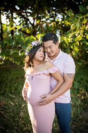 This Couple Matched In A Beautiful Shade Of Blush Pink She Wore A Ruffled Off The Shoulder Dress Tha Family Photo Outfits Photo Outfit Family Maternity Photos