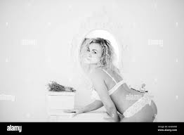 Curly blonde girl in underwear bent over and show her ass background mirror  indoor white room Stock Photo - Alamy