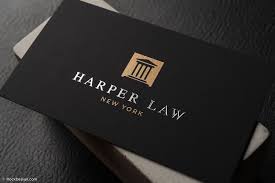 Photo of female lawyer writes down number from business card in documents, sits at desktop with laptop computer, mobile phone and documents. Professional Foil Stamped Lawyer Business Card Template Harper Law