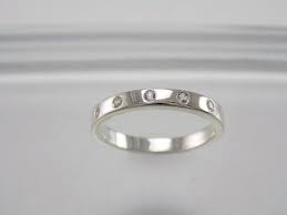 This Is A Simple And Elegant Sterling Silver 2mm Band Containing Five Embedded White Sapphire Stones The Stackable Simple Engagement Rings Rings Rings Simple