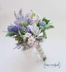 A winter wedding bouquet of ivory hydrangea with tucks of red hypericum berries and pine cones. Pin By Lynne Aubry On Ivory Lace And A Dolled Up Face Flower Bouquet Wedding Wildflower Bouquet Wildflower Wedding Bouquet