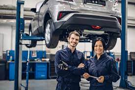 Auto Car Repair Service Center Two Happy Mechanics Man And Woman Standing By The Car Car Repair Service Mechanic Man Auto Repair
