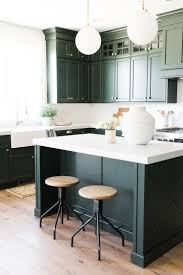 A deep forest green island and stools add a jolt of drama to the white kitchen in architect reinaldo leandro and designer patrick mcgrath's hamptons cottage. Blog Interior Design Pensacola 3a Design Studio Kitchen Cabinet Design Dark Green Kitchen Green Kitchen Cabinets