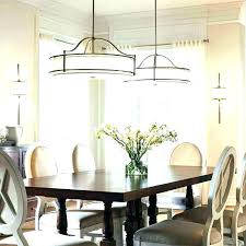 Modern midcentury kitchen with black island, hardwood floors, high ceiling, stylish pendant lights, and tall windows. Farmhouse Kitchen Table Lighting Ideas