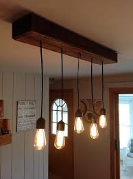 Shut off the power to the room from the breaker box to prevent shock when you remove the chandelier. This Light Fixture Was Created With Used Pallet Wood To Create The Box With Hanging Edison Bulbs Wood Light Fixture Bar Light Fixtures Light Fixtures