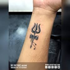Small tattoos come in cute designs. 181 Tattooz Studio A Small Design Of Trishul With Damroo On Wrist With Slight Shading In Damroo One Of The Best Small Tattoo Designs Of Trishul One Can Get Inked For